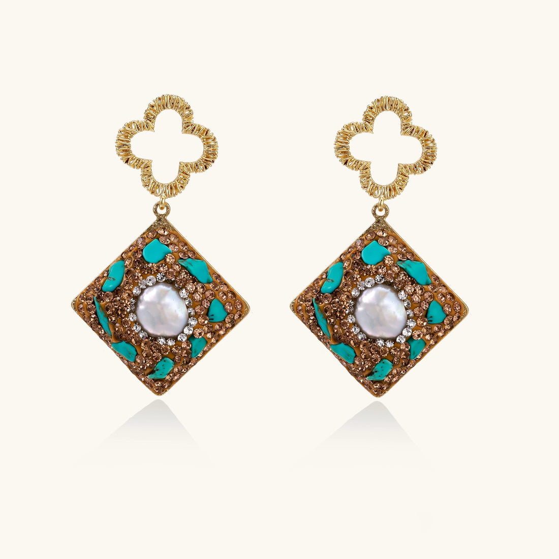 Gold-plated drop earrings with quatrefoil studs, diamond-shaped pendants featuring baroque pearls, turquoise stones, and amber crystals